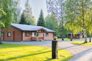 A rustic lodge with a wooden exterior, a covered porch, and a well-maintained lawn. - Hapimag Resort Punkaharju (Savonlinna)