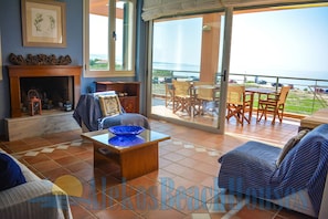 Cozy up by the fireplace and enjoy the ocean view through large sliding glass doors.