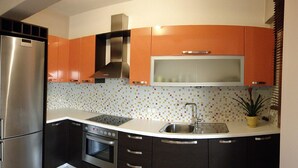 A kitchen with a stainless steel refrigerator, an oven, a microwave, and a sink. - Alekos Beach Houses-Angelo (Kefalonia)