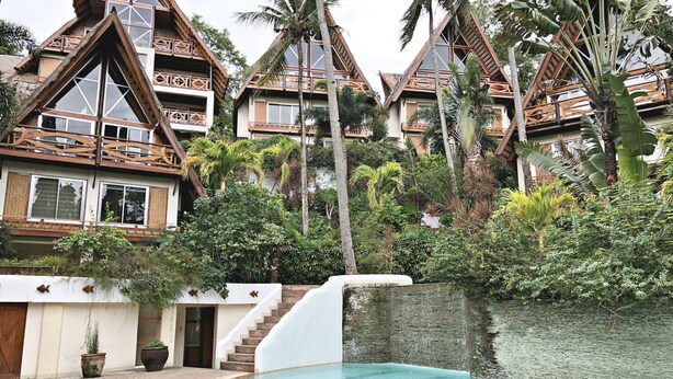 A resort with multiple bungalow-style buildings, a swimming pool, and lush tropical vegetation. - Waimea Luxury Houses - Adults Only (Puerto Galera)