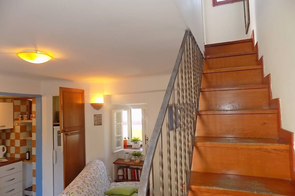 A staircase with wooden steps and a metal railing.
