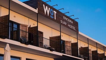 Ericeira Surf Hostel features a modern design with a flat roof and balconies.