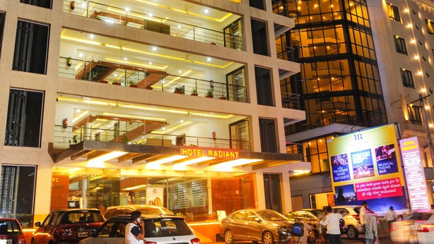 A multi-story hotel with a modern design, featuring balconies and large windows. - Hotel Radiant (Kolhapur)