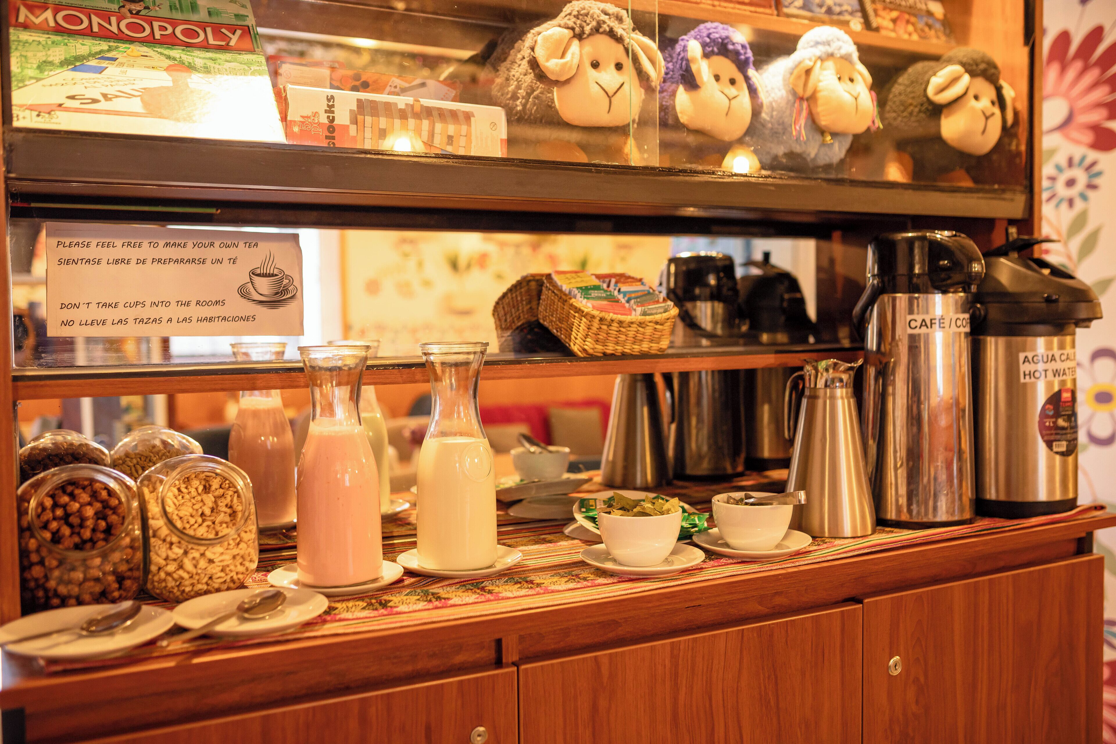 A buffet area with various food items, a coffee station, and a Monopoly game on the shelf.