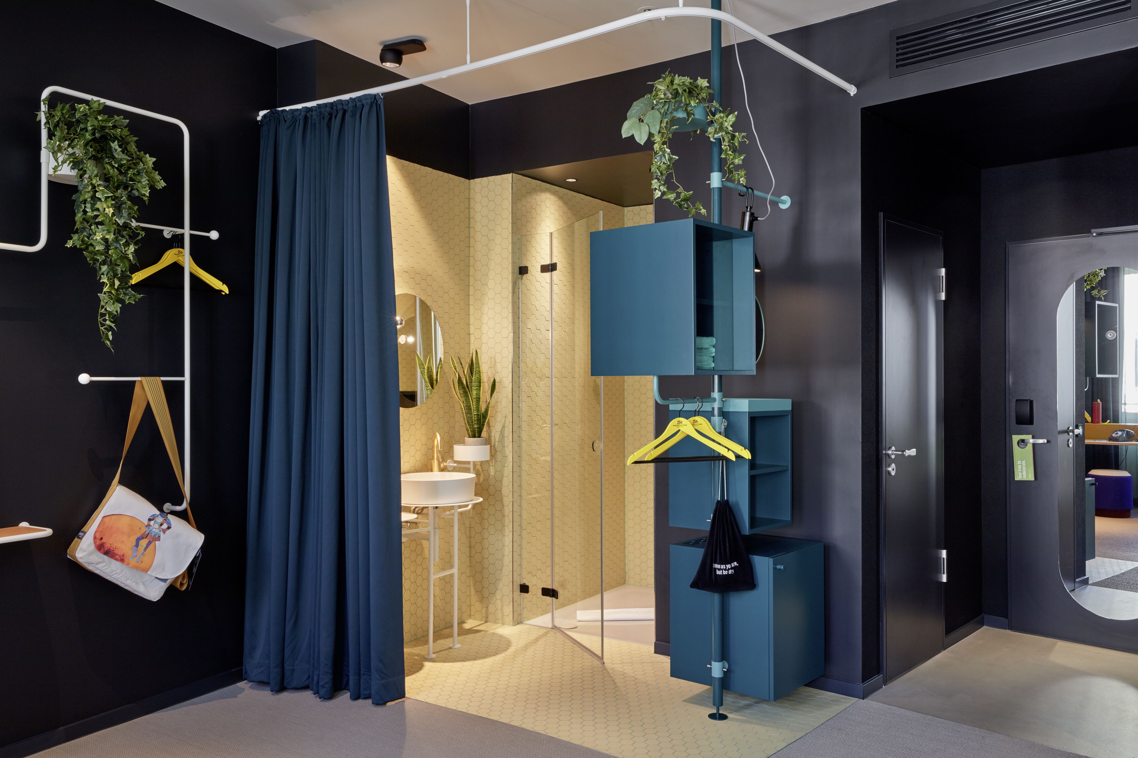 A modern bathroom with a glass shower, a sink, and a mirror.