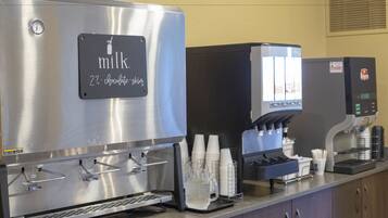 A coffee machine with a milk dispenser and a coffee maker.