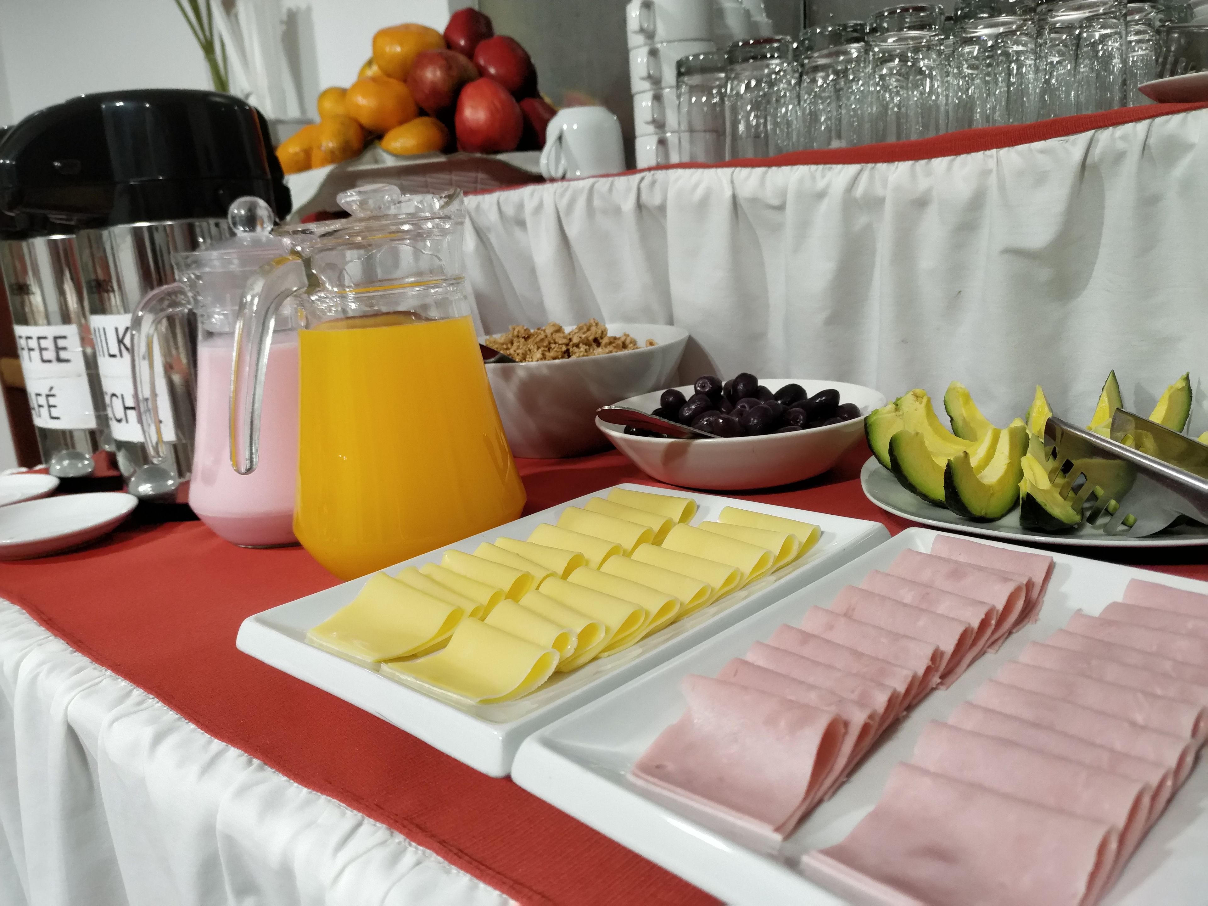 A breakfast buffet with various food items and beverages.