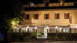 A building with a sign reading "Locanda San Lorenzo" at night. - Locanda San Lorenzo (Alpago)