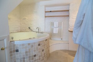 A bathroom with a freestanding bathtub, a white towel rack, and a tiled floor. - Forbes of Kingennie Country Resort (Dundee)