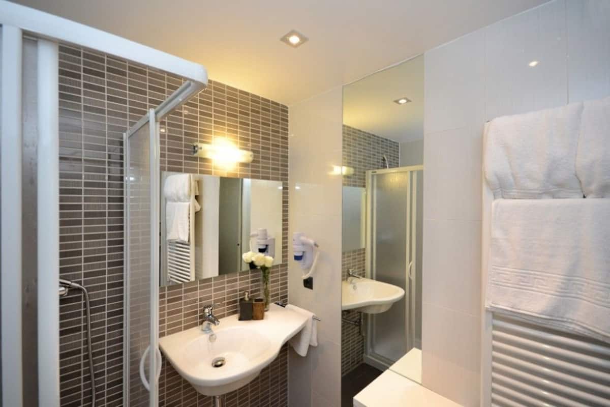 designer toiletries, hair dryer, towels