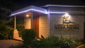 A building with a sign reading "LOTFA RESORT DIANI BEACH ROAD, KENYA" and a palm tree emblem. - Lotfa Resort Diani (Diani Beach)