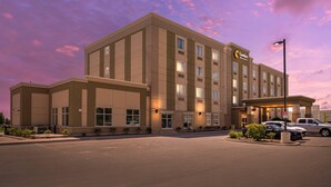 A large hotel with a modern design, multiple floors, and a parking lot. - Comfort Inn & Suites (Clarington)