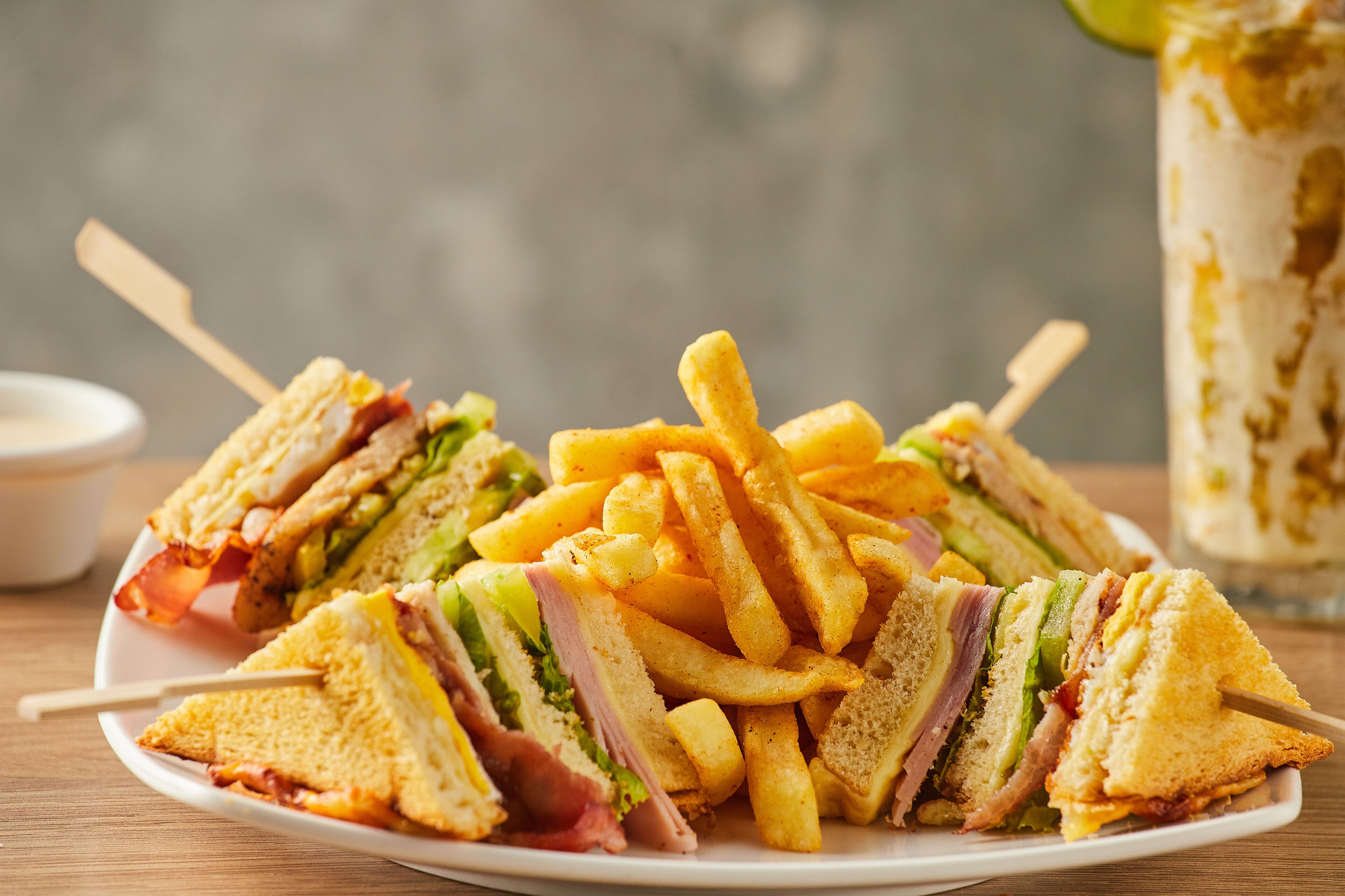 A plate of sandwiches and French fries.