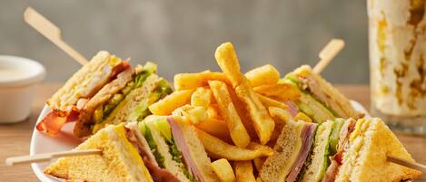 A plate of sandwiches and French fries.