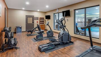 A gym with treadmills, elliptical machines, and weight machines.