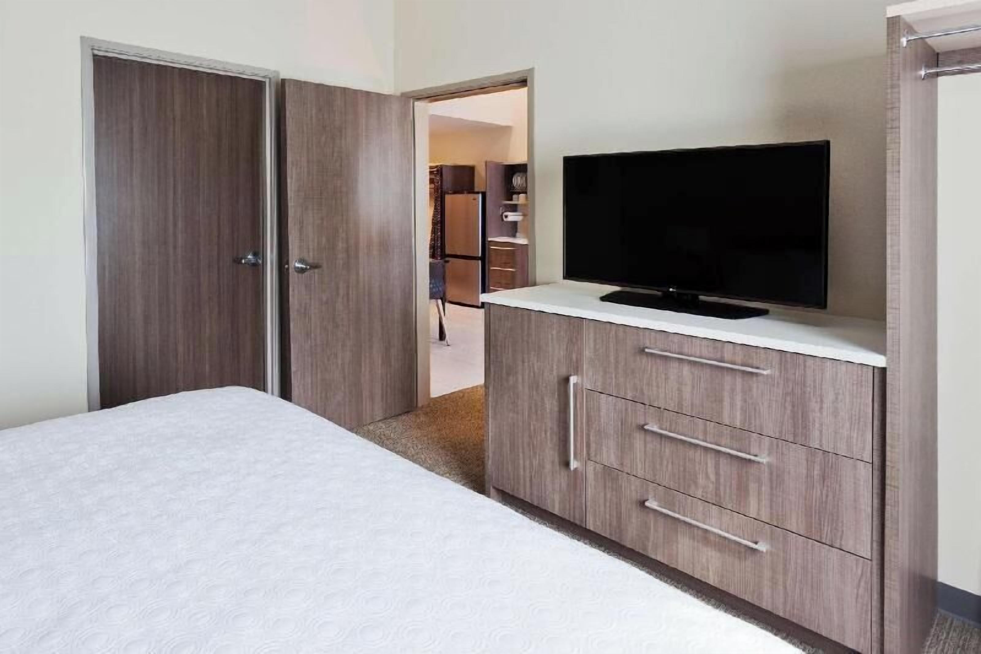 Premium bedding, desk, laptop workspace, blackout drapes