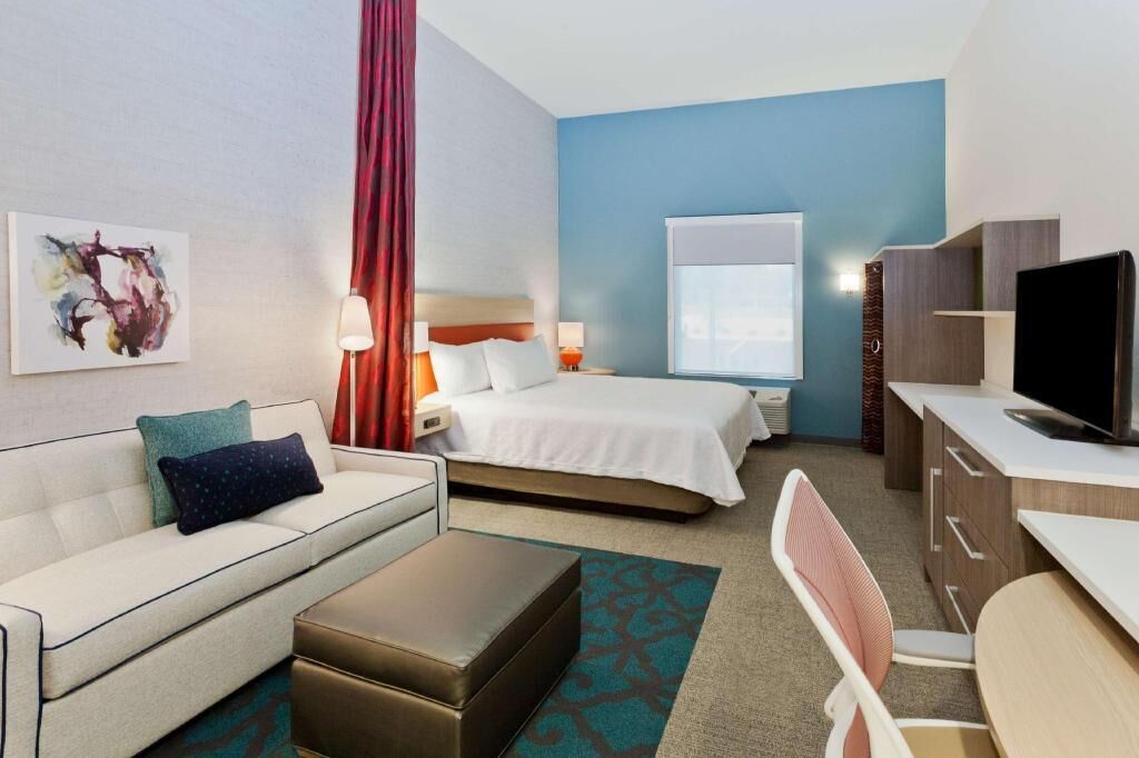 Premium bedding, desk, laptop workspace, blackout drapes