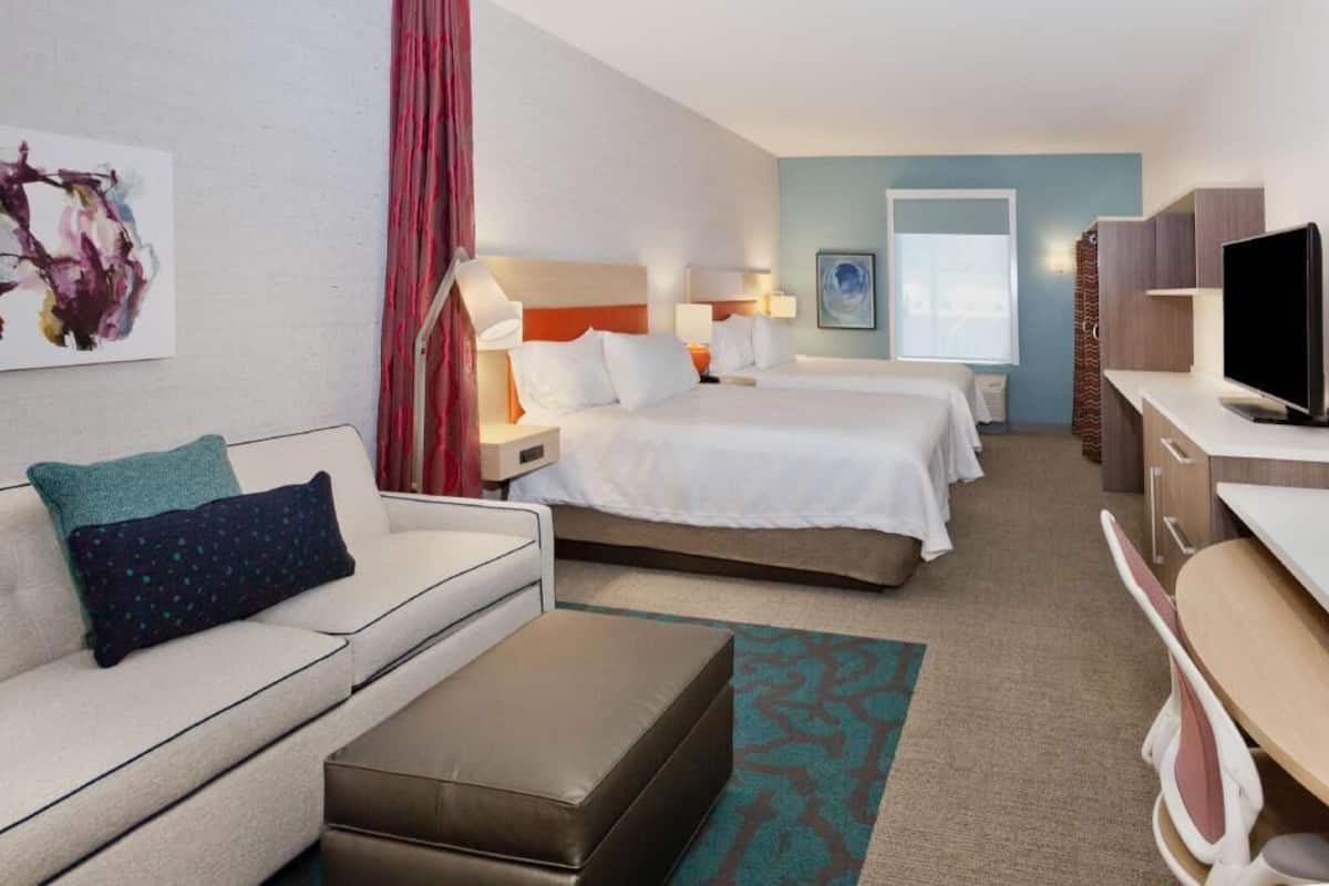 Premium bedding, desk, laptop workspace, blackout drapes