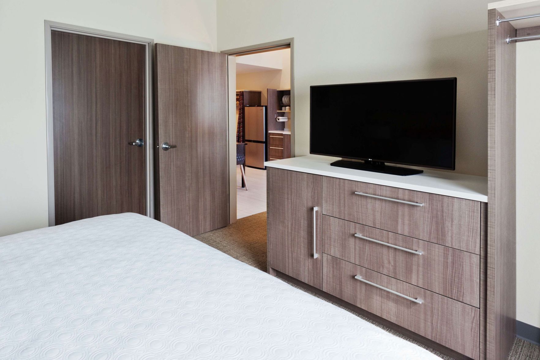 Premium bedding, desk, laptop workspace, blackout drapes