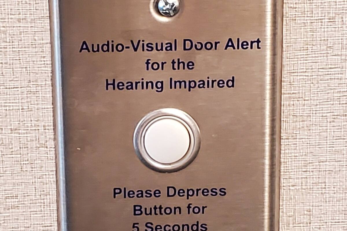 A doorbell with instructions for the hearing impaired.