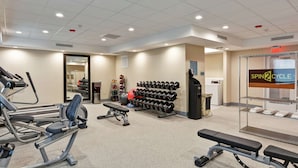 A gym with various exercise equipment, including treadmills, dumbbells, and weight benches. - Home2 Suites by Hilton La Porte (La Porte)