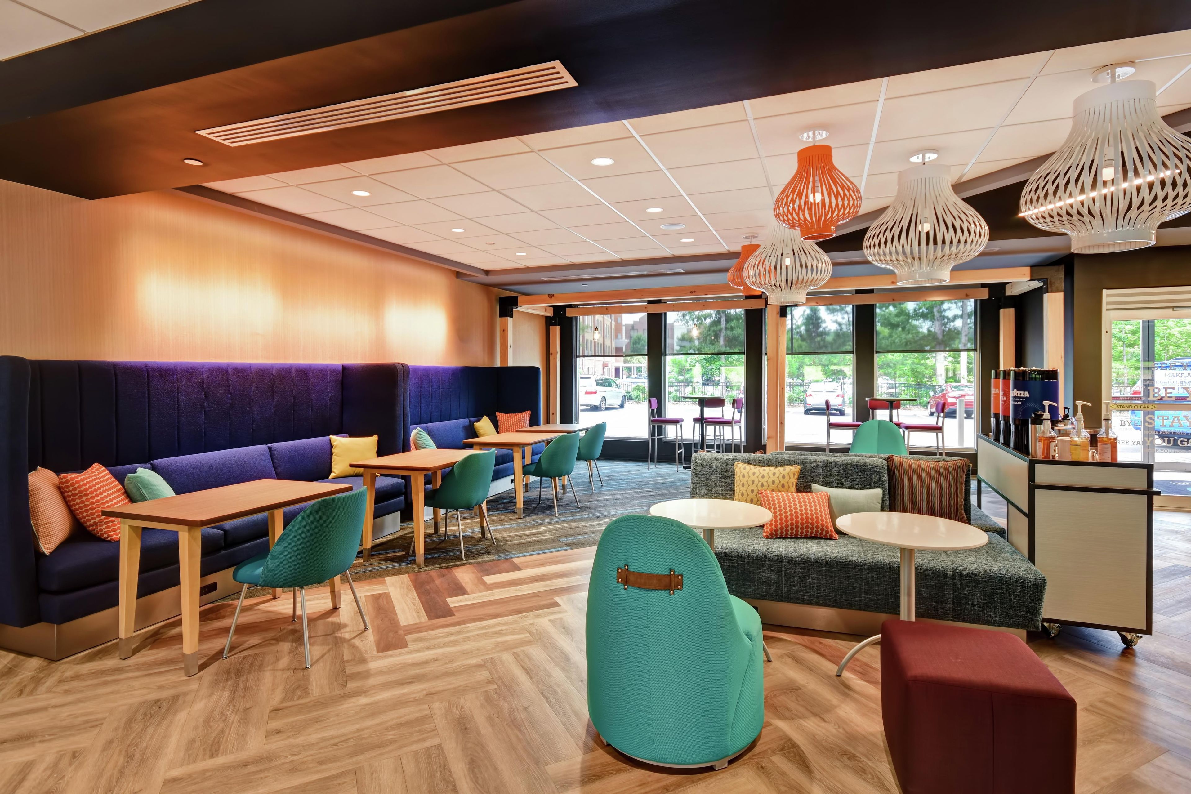 A modern interior with seating areas, tables, and a view of the outdoors.