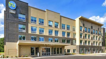 A modern hotel with a brick facade, multiple windows, and a clear sky.