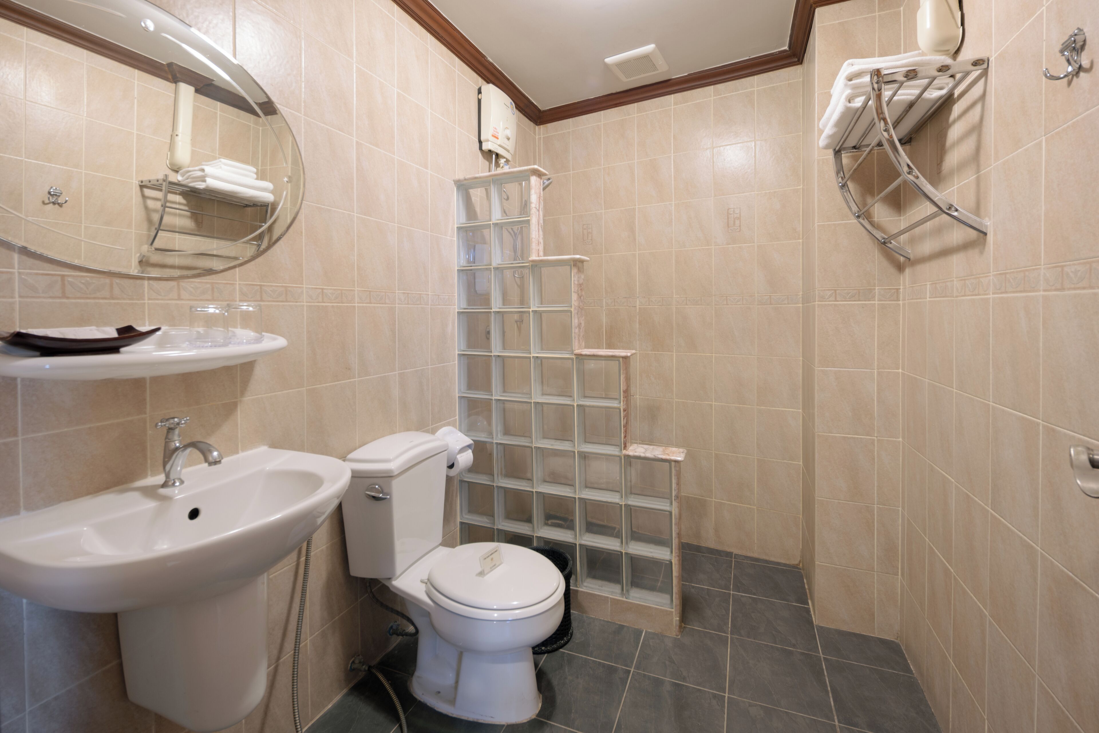 A bathroom with a sink, toilet, and shower.