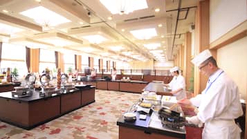 A buffet setup in a spacious room with a high ceiling and large windows.