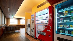 A vending machine area with a Coca-Cola machine, a water dispenser, and a snack vending machine. - ホテルB4T角館 (Senboku)