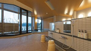 A modern indoor pool area with large windows, a tiled floor, and a shower area with hand soap dispensers. - Sanriku Hana Hotel Hamagiku (Otsuchi-cho)