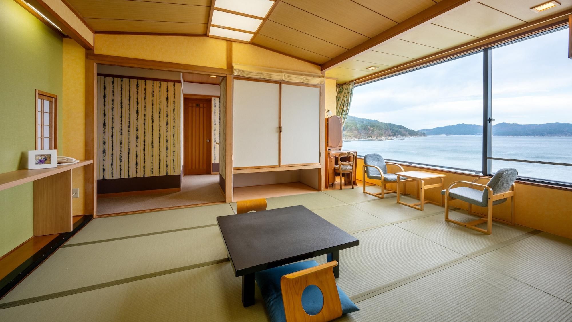 A room with tatami flooring, a low table, and seating.