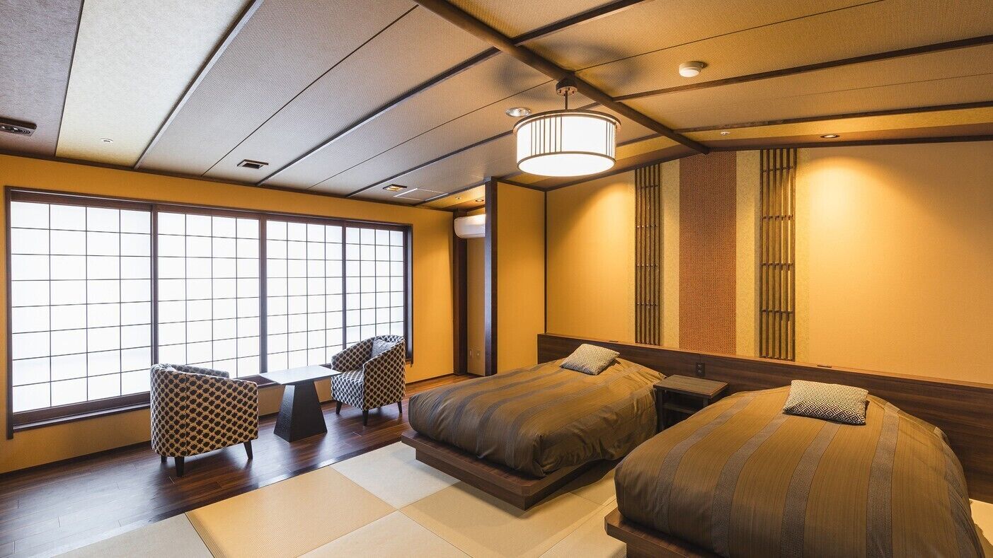A traditional Japanese-style bedroom with tatami flooring, a shoji screen, and a large window.