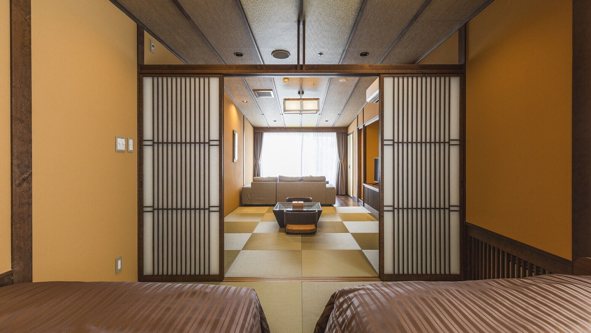 A traditional Japanese-style room with tatami flooring, a low table, and sliding doors.