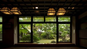A room with large windows offering a view of a garden. - Kazennosyo (Kuroishi)