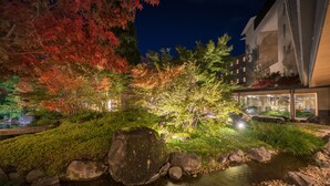 A nighttime garden with a stream, rocks, and illuminated foliage. - Surikamitei Ohtori (Fukushima)