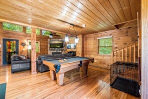 A wooden interior with a pool table, leather sofa, and a staircase. - Twilight Point Pet Friendly! Book NOW and receive tickets to Dollywood, Anakeesta and many more (Gatlinburg)