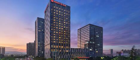 A modern high-rise building with the name "Wanda Realm" prominently displayed at the top.
