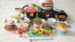A variety of Japanese dishes, including sushi, sashimi, and a hot pot, arranged on a table. - Miyako Hotel Sawadaya (Miyako)