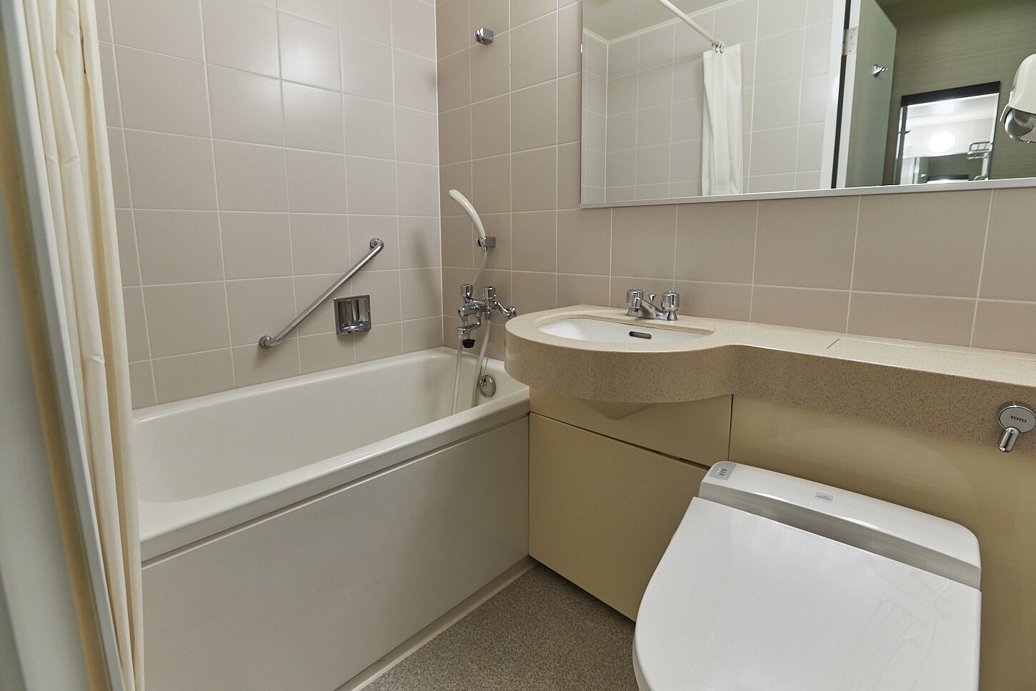 A bathroom with a bathtub, a sink, and a toilet.