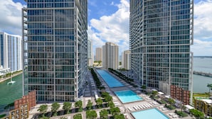 A high-rise hotel with a rooftop pool, multiple balconies, and a view of the water. - Icon Residences (Miami)