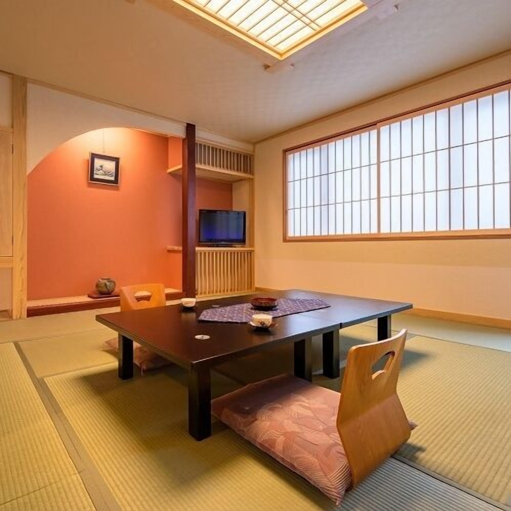 A traditional Japanese room with tatami flooring, a low table, and sliding doors.
