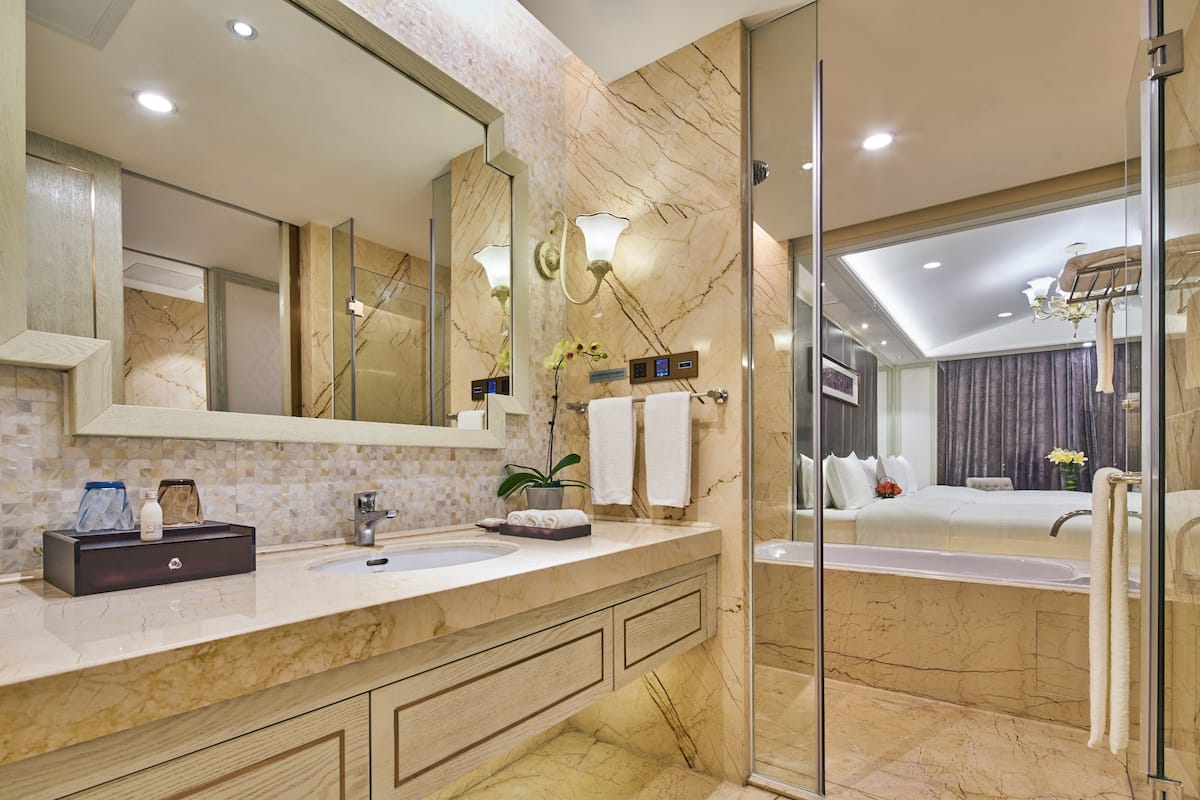 separate bathtub and shower, hair dryer, slippers, towels