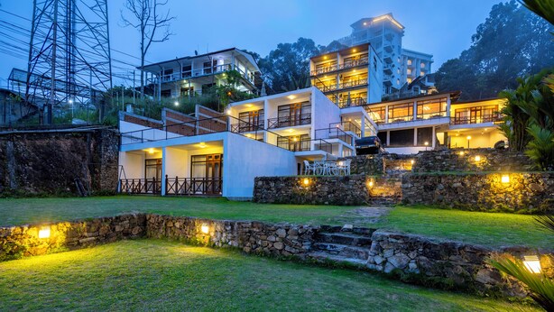 A modern hotel with multiple floors, stone walls, and outdoor seating areas. - Hotel Alta Vista (Ella)
