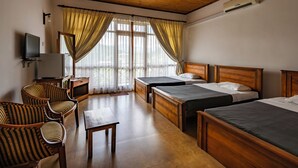 A hotel room with two beds, a television, a desk, and a chair. - Hotel Alta Vista (Ella)