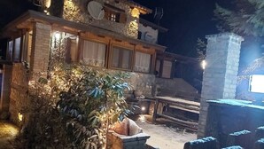 A rustic stone building with a wooden deck and a stone chimney. - Family Abode for Vacation in Arachova (Distomo-Arachova-Antikyra)