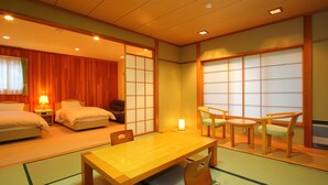 A traditional Japanese-style room with tatami flooring, a low wooden table, and a sliding shoji screen door. - Hatago SAKURAYA (Yamanakako)