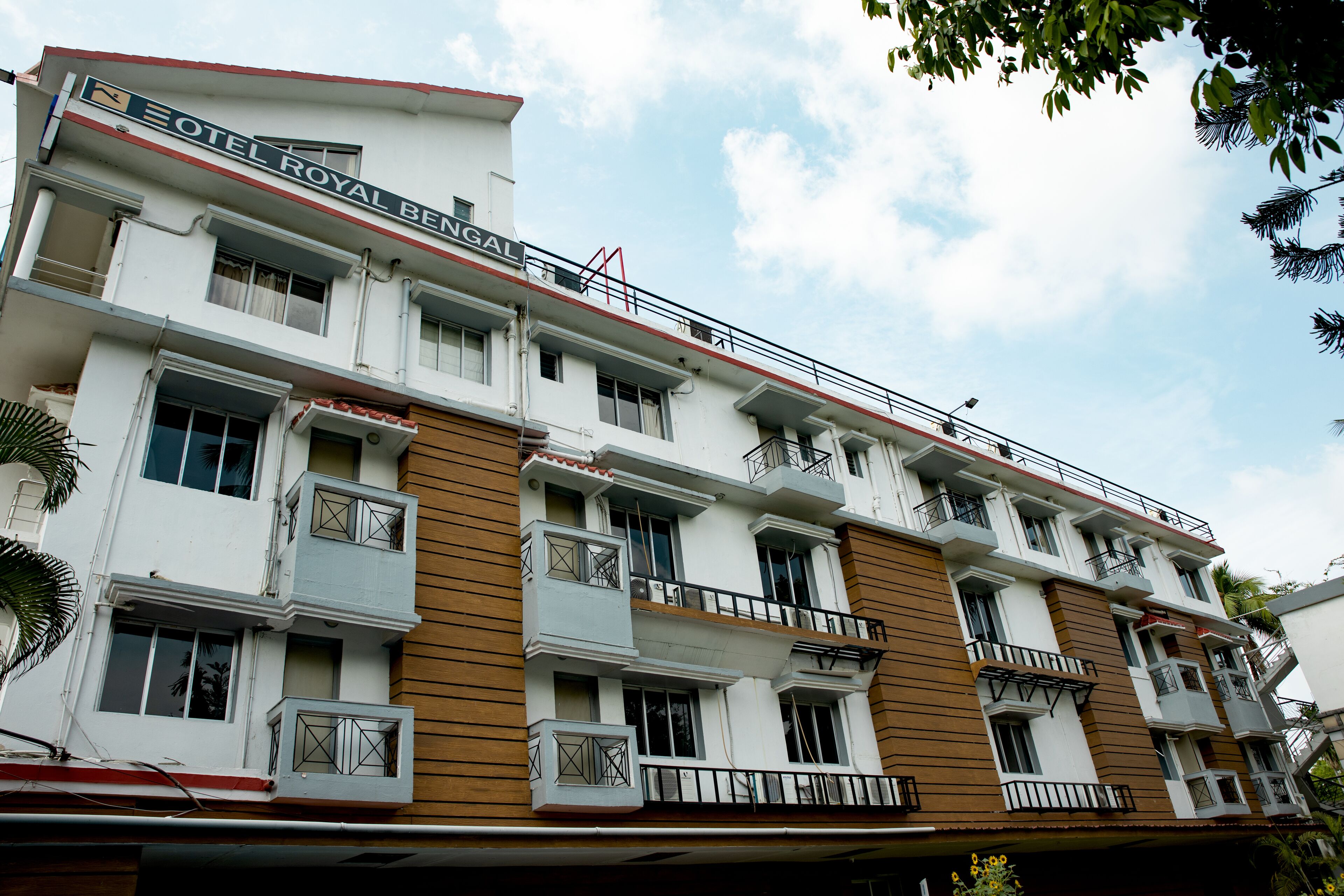 A multi-story building with balconies and a sign reading "HOTEL ROYAL BENGAL".