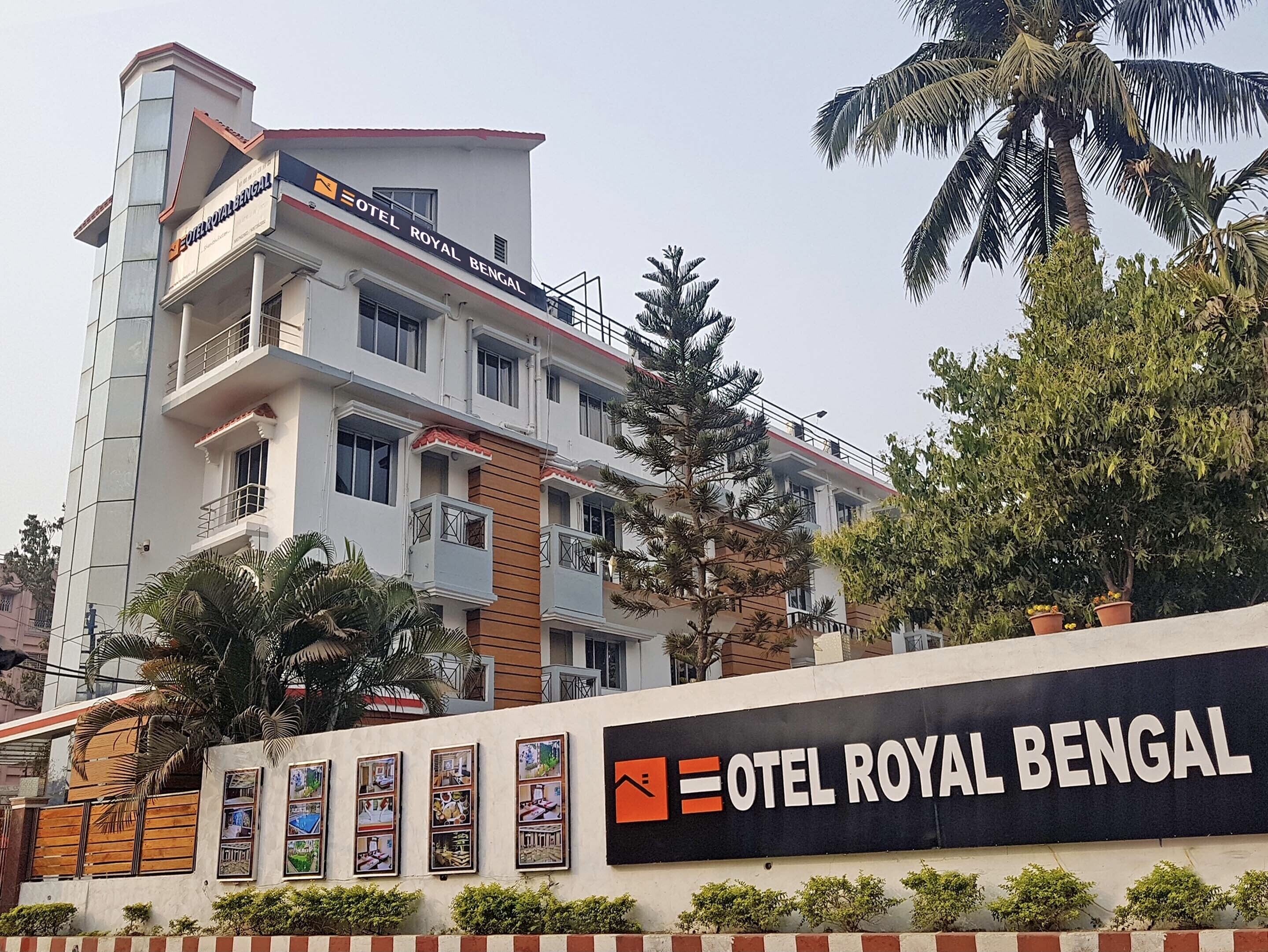 A multi-story building with balconies and a sign for "Hotel Royal Bengal".