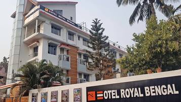 A multi-story building with balconies and a sign for "Hotel Royal Bengal".